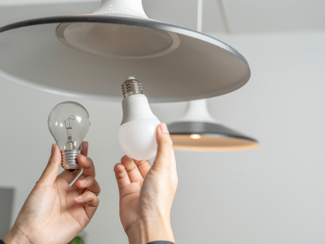 Person changing light bulb. 